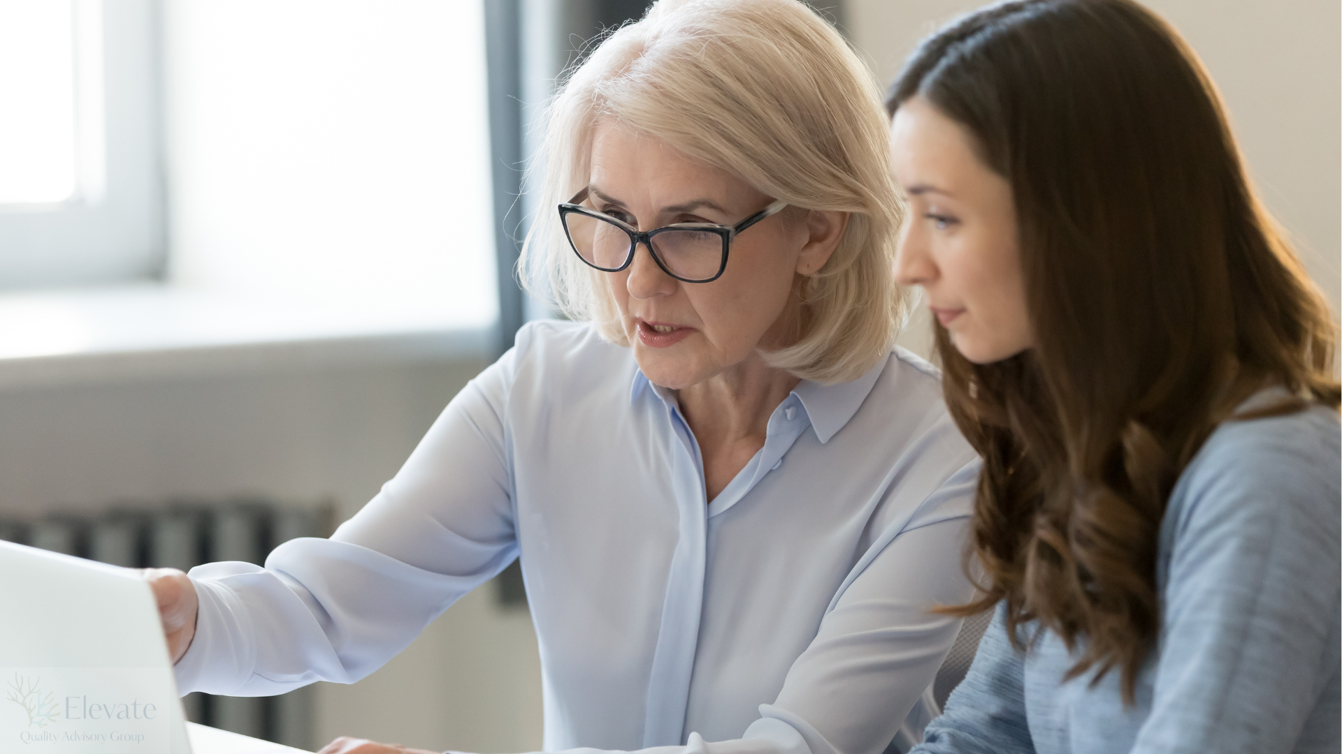 Two professionals reviewing quality and audit findings together